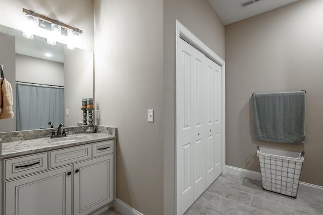 bathroom with tile patterned flooring and vanity