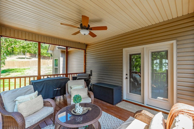 sunroom featuring ceiling fan