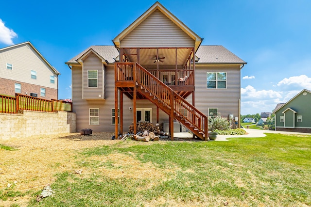 back of property with a lawn and a wooden deck