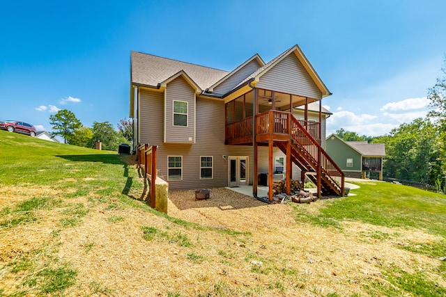 back of house with a lawn, a patio, and a deck