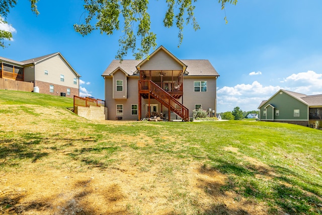 rear view of property featuring a yard and a deck