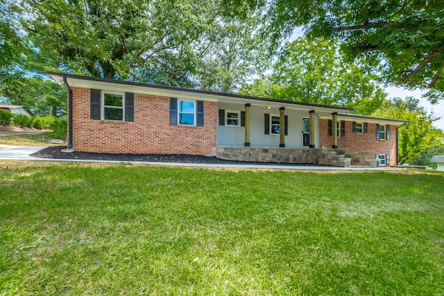 single story home featuring brick siding, covered porch, and a front lawn