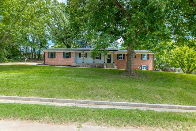 ranch-style home featuring brick siding and a front lawn