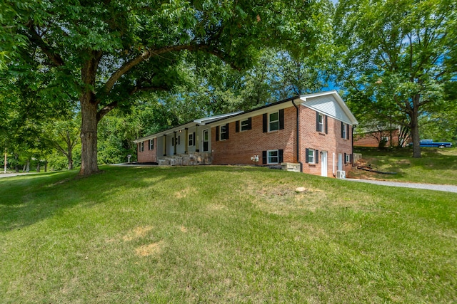 view of side of home with a yard