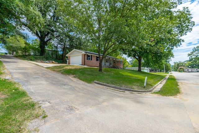 ranch-style home with a garage and a front yard