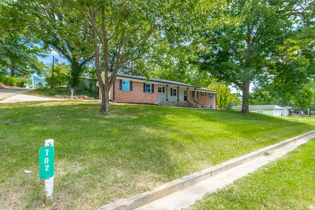 ranch-style home with a front lawn