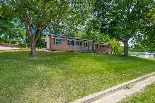 ranch-style home featuring a front yard