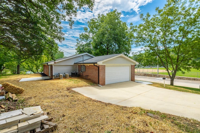 ranch-style house with central AC and a garage