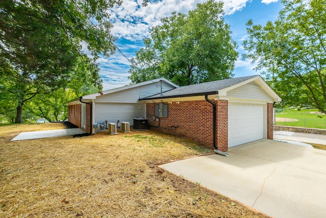 view of front of home with central AC and a front yard