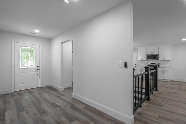 entryway with hardwood / wood-style floors