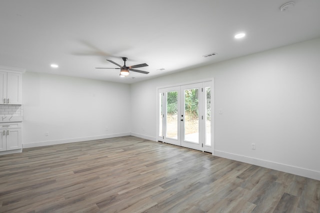 unfurnished living room featuring french doors, wood-type flooring, and ceiling fan