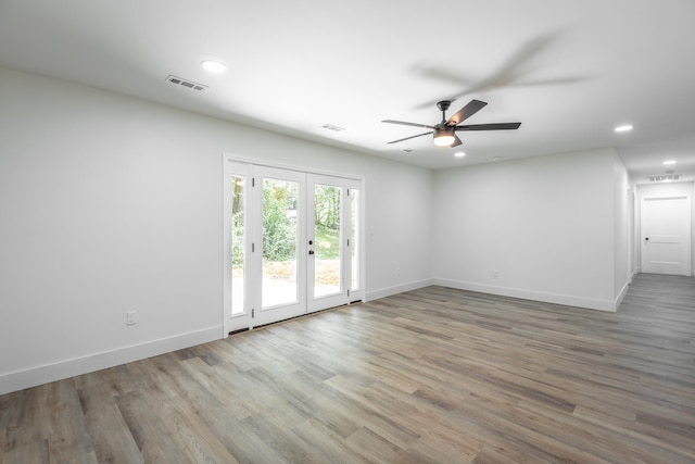 spare room with hardwood / wood-style floors, ceiling fan, and french doors