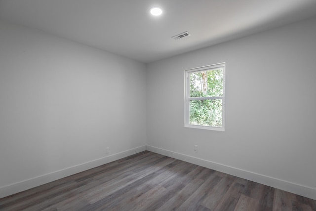 empty room with dark hardwood / wood-style flooring