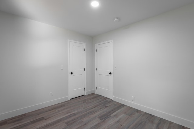 spare room featuring wood-type flooring