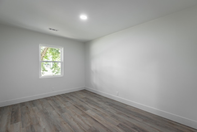 spare room featuring wood-type flooring