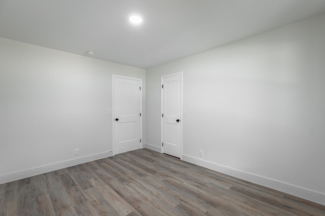 spare room with wood-type flooring