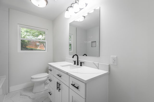 bathroom with vanity, toilet, and a tub