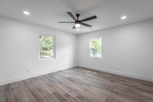 empty room with hardwood / wood-style flooring and ceiling fan