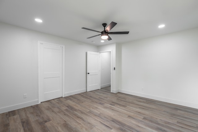 unfurnished bedroom with ceiling fan and hardwood / wood-style flooring