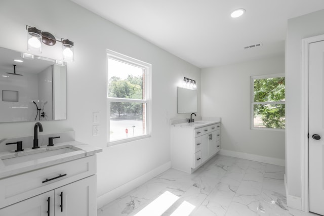 bathroom featuring a wealth of natural light and vanity