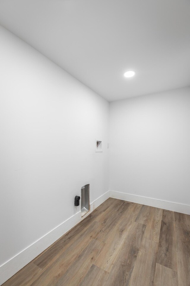 clothes washing area featuring hookup for a washing machine and wood-type flooring