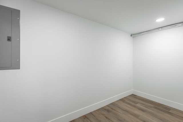 empty room with wood-type flooring and electric panel