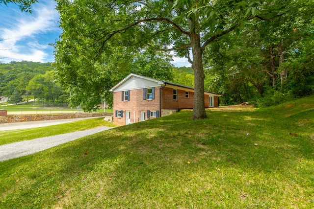 view of side of property with a yard