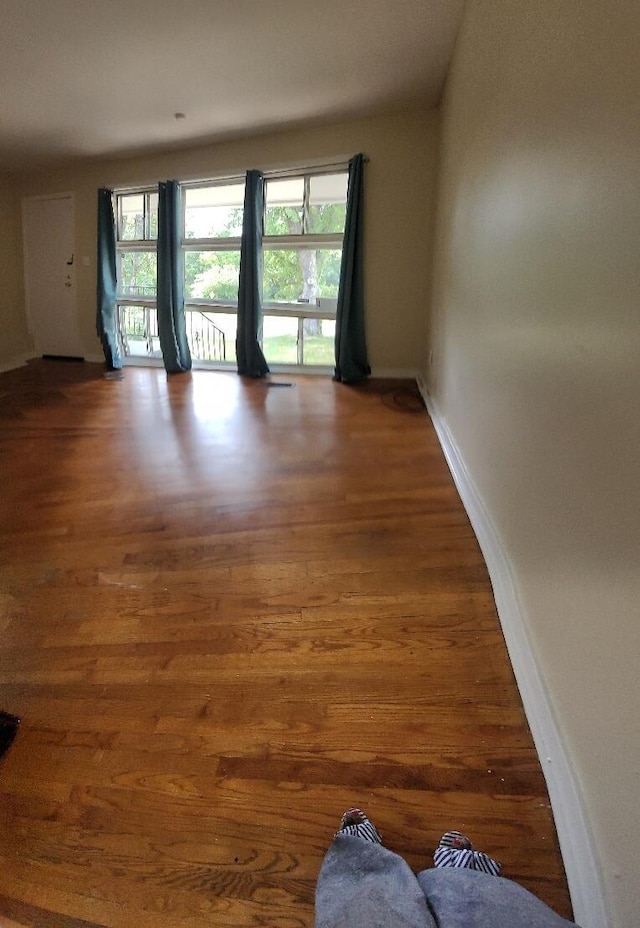 unfurnished room with wood-type flooring