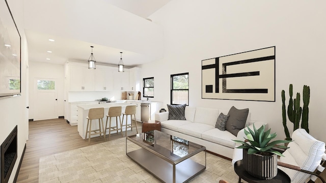 living room featuring a high ceiling and light hardwood / wood-style flooring