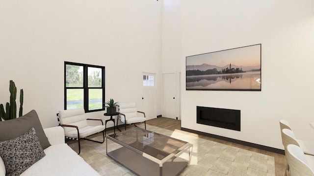 living room featuring light wood-type flooring and a high ceiling