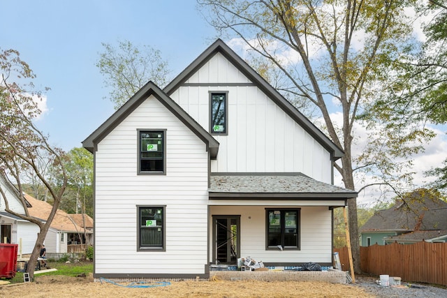 rear view of property featuring a porch