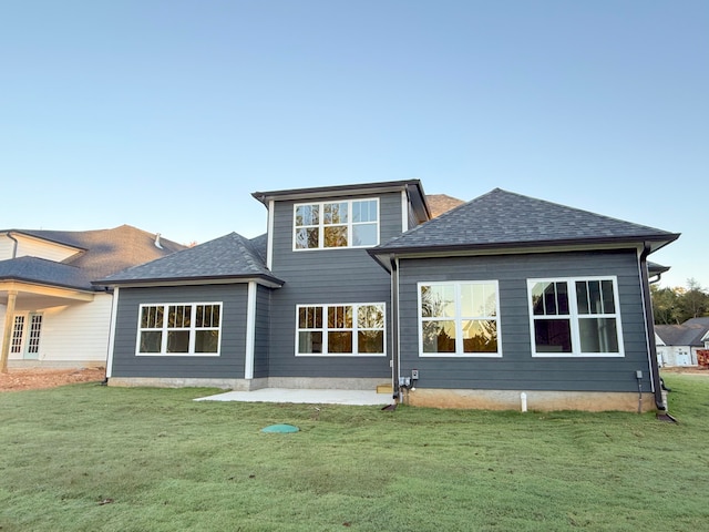 rear view of property with a patio area and a lawn