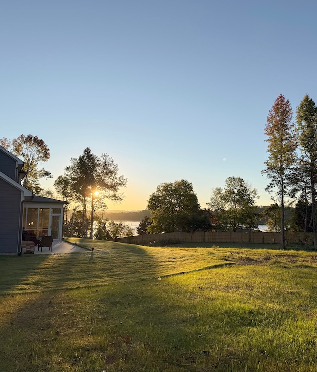 yard at dusk with a patio area