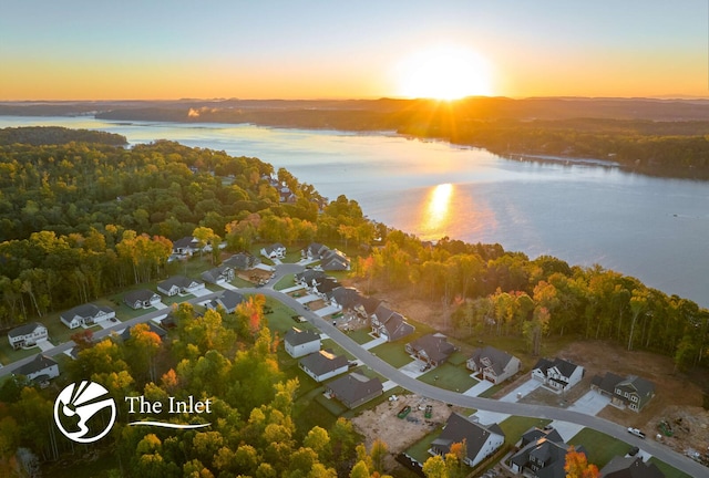 aerial view at dusk with a water view