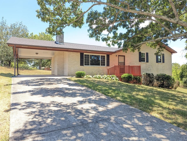 ranch-style house with a front yard and a carport