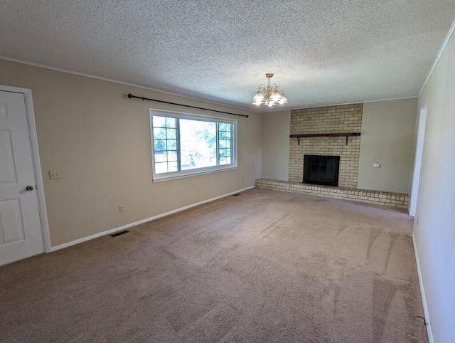 unfurnished living room featuring a textured ceiling, a brick fireplace, an inviting chandelier, and carpet floors