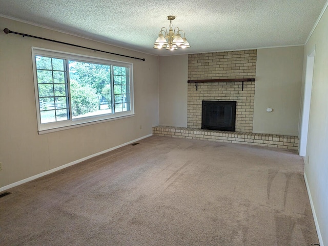 unfurnished living room with a textured ceiling, a notable chandelier, and a fireplace