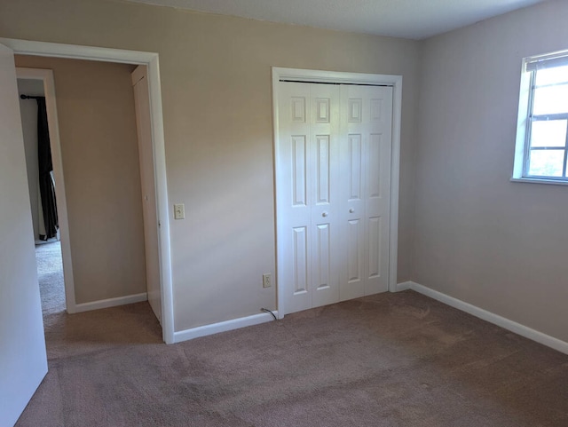 unfurnished bedroom with a closet and carpet