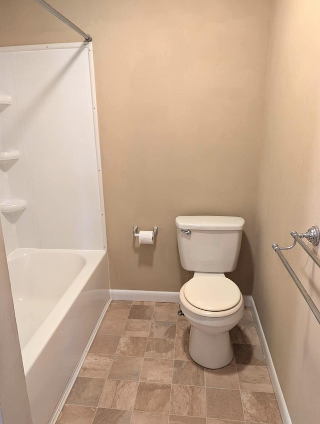 bathroom featuring toilet and tub / shower combination