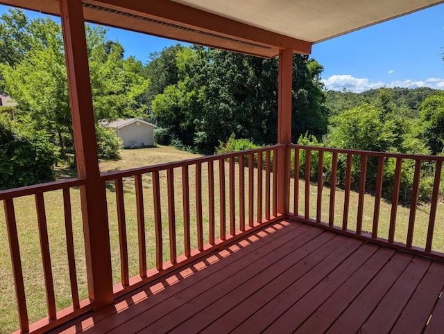 wooden terrace with a lawn