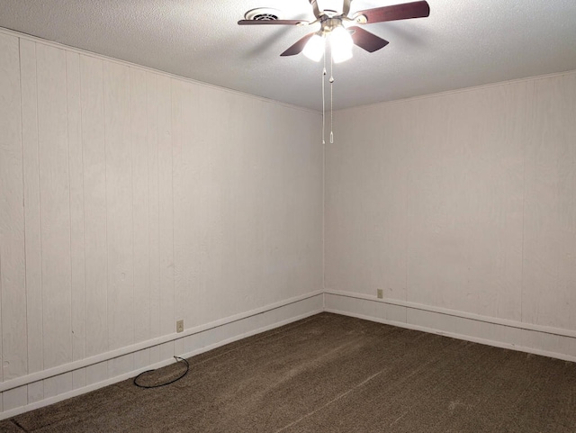 carpeted empty room with ceiling fan and a textured ceiling