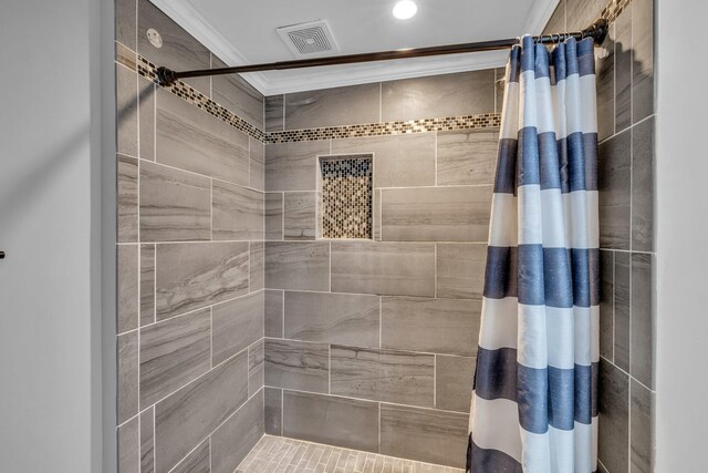 bathroom with crown molding and walk in shower