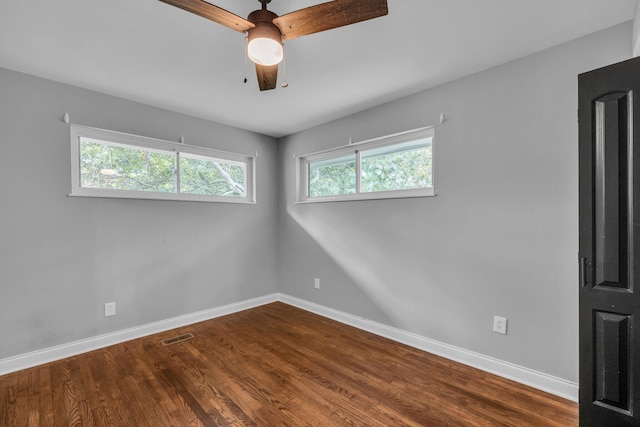 empty room featuring ceiling fan and hardwood / wood-style floors