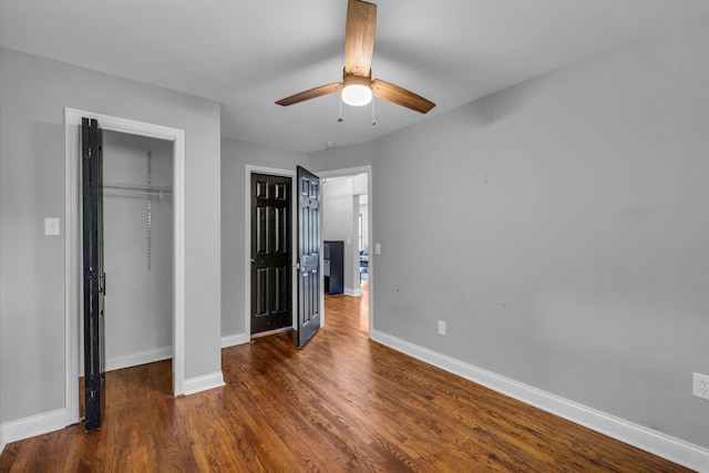 unfurnished bedroom featuring ceiling fan and dark wood-type flooring