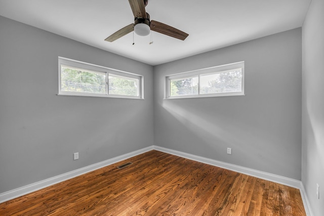 empty room featuring hardwood / wood-style floors and ceiling fan