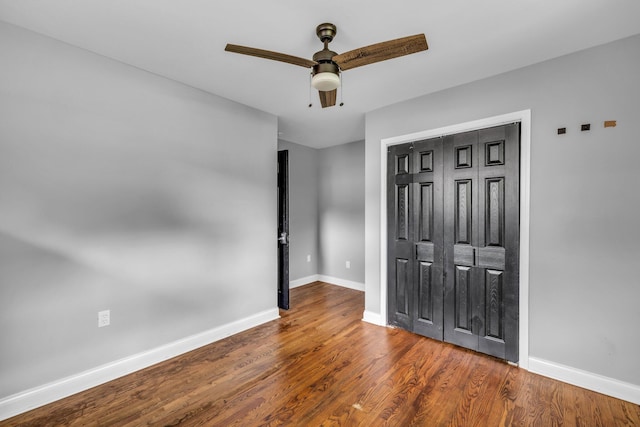 unfurnished bedroom with hardwood / wood-style floors, a closet, and ceiling fan