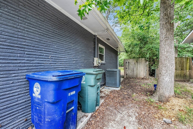 view of side of home with central air condition unit