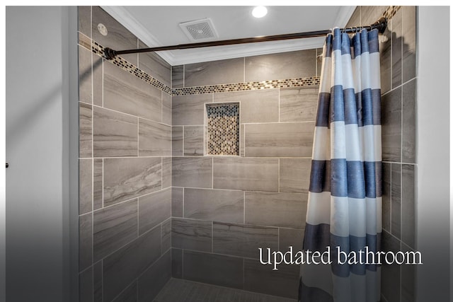 bathroom featuring a shower with shower curtain and crown molding