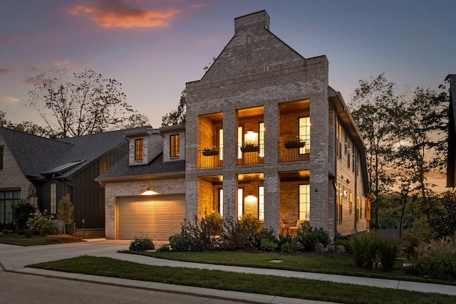 view of front of house with a yard and a garage