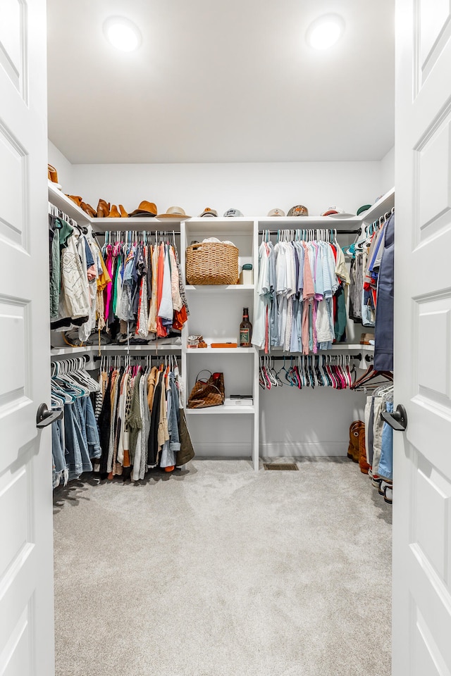 spacious closet with carpet flooring